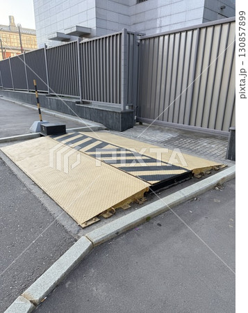 Automated car parking barrier in urban setting, emphasizing modern infrastructure design Automated car parking barrier in urban setting, emphasizing modern infrastructure design 130857899