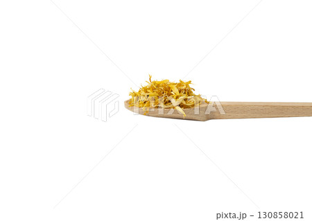 Dried Calendula or Marigold petals on wooden spoon isolated on white background. Dried Calendula or Marigold petals on wooden spoon isolated on white background. 130858021