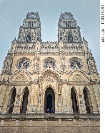 The magnificent Flamboyant Gothic Orleans Cathedral of the Holy Cross on a rainy day. French basilique Sainte-Croix ornate with twin towers and a large rose windows 130858195