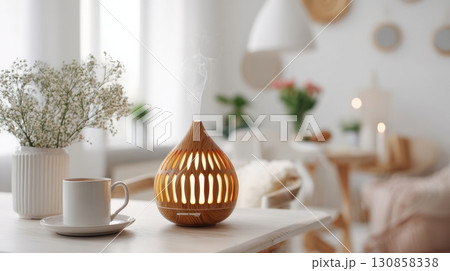 Wooden essential oil diffuser releasing mist 130858338