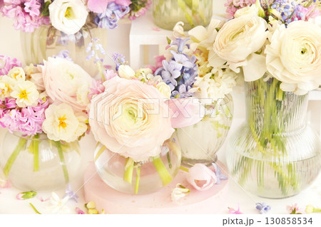 Summer blossoming delicate ranunculus on spring blooming flowers festive background, bright and soft springtime bouquet floral card, selective focus Summer blossoming delicate ranunculus on spring blooming flowers festive background, bright and soft springtime bouquet floral card, selective focus 130858534