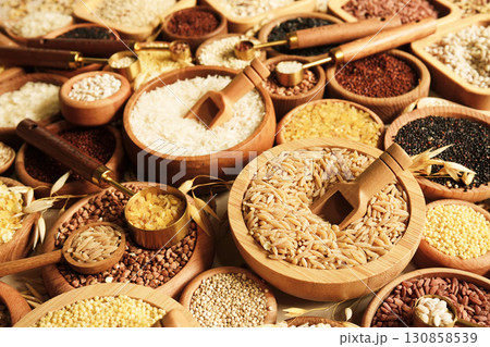 Colorful mix of grain varieties: oat and wheat, rice and millet, buckwheat and barley, quinoa and polenta. Food ingridients for healthy diet. Selective focus Colorful mix of grain varieties: oat and wheat, rice and millet, buckwheat and barley, quinoa and polenta. Food ingridients for healthy diet. Selective focus 130858539