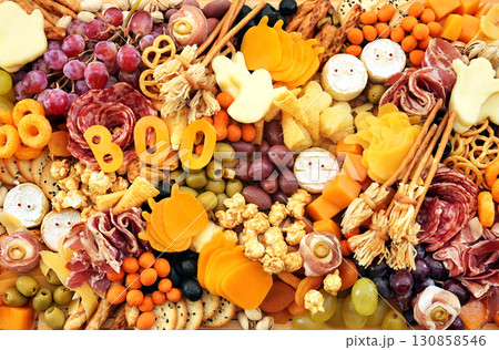 Halloween charcuterie board fun food mix: ghosts, mummies, pumpkins, eyes, brooms. Party spooky salty snacks Halloween charcuterie board fun food mix: ghosts, mummies, pumpkins, eyes, brooms. Party spooky salty snacks 130858546