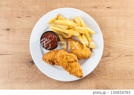 Crispy fried chicken tenders with french fries Crispy fried chicken tenders with french fries 130858765