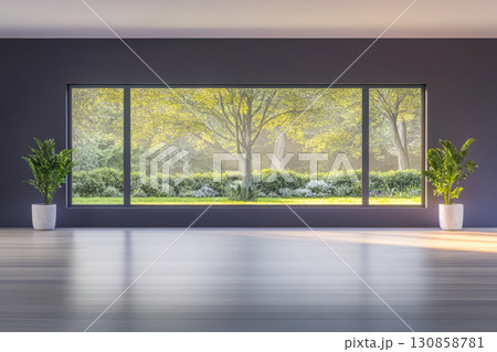 Bright and serene interior showcasing large windows with a view of a lush garden in a modern space 130858781