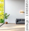 Modern interior design featuring a cozy sofa and indoor plant in a sunlit space 130858853