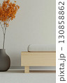 Minimalist interior design featuring a wooden bench and a decorative plant in warm hues 130858862