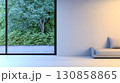 Modern interior design featuring a large window with a lush green view in a contemporary living space 130858865