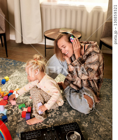 Mother and child bonding during playtime with blocks and music at home Mother and child bonding during playtime with blocks and music at home 130859321