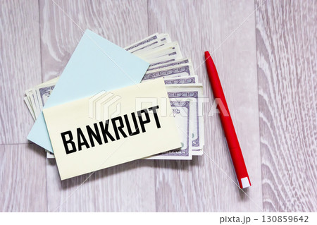 The word "bankrupt" is written on the sticker that lies on the hundred dollar bills. The word "bankrupt" is written on the sticker that lies on the hundred dollar bills. 130859642