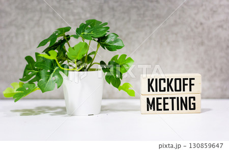 A desk with wooden blocks. text Kickoff meeting A desk with wooden blocks. text Kickoff meeting 130859647