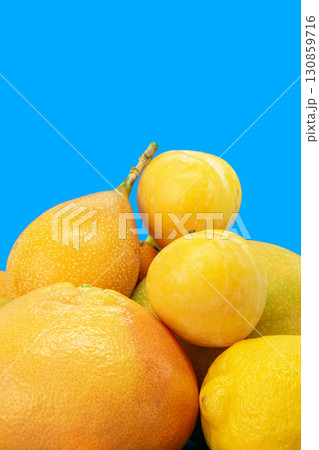 Composition of yellow citrus fruits in blue background 130859716