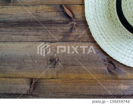 Summer vacation, flatlay. Hat on a dark wooden background. 130859748