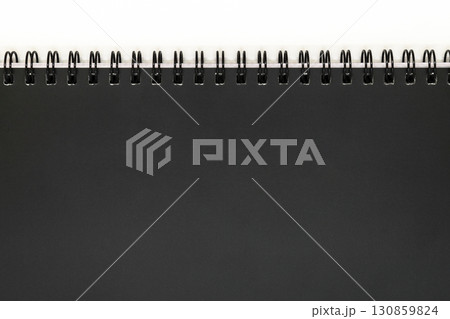 Background of Black Notebook Cover with Black Metal Spirals with Free Copy Space 130859824