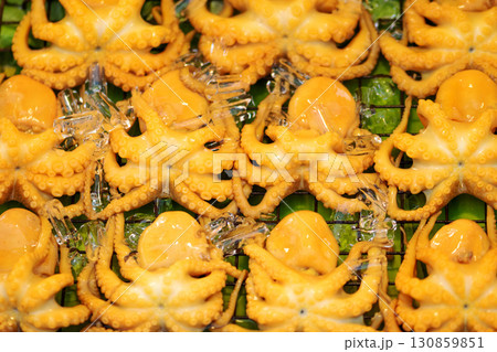 Background of yellow squids on green banana leaf 130859851