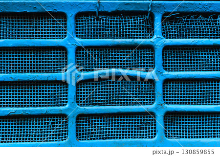 Background surface of blue and damaged metallic grid 130859855