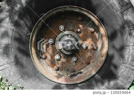 Background Surface of Old and Dirty Tire with Rusty Disc 130859864