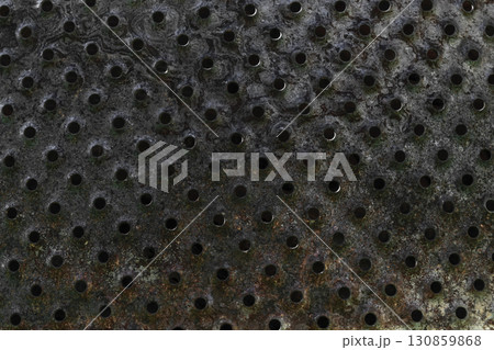Background Surface of Old, Burned and Rusty Metal Plate with Holes Background Surface of Old, Burned and Rusty Metal Plate with Holes 130859868