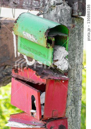 Green and red very old post boxes hanging on pole Green and red very old post boxes hanging on pole 130860186