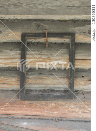 Old wooden dark frames hanging on rural wooden wall 130860331