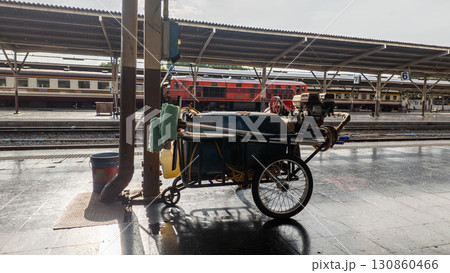cleaning cart with hose and bucket at railway station, mobile trolley for platform sanitation, daily rail service and maintenance routine cleaning cart with hose and bucket at railway station, mobile trolley for platform sanitation, daily rail service and maintenance routine 130860466