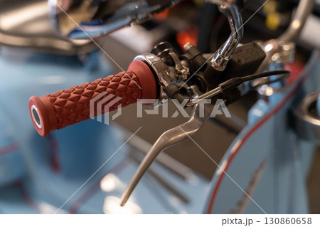 Red handle grip and brake lever of vintage scooter Red handle grip and brake lever of vintage scooter 130860658