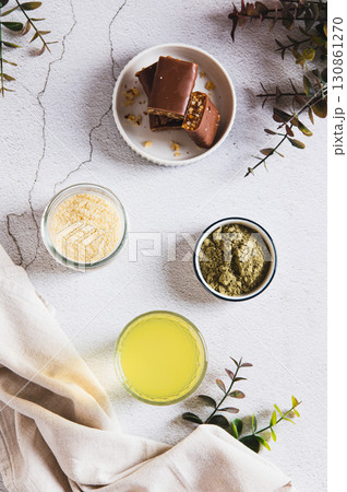 Matcha tea with protein powder in a glass and bars on the table top and vertical view Matcha tea with protein powder in a glass and bars on the table top and vertical view 130861270