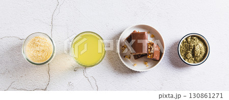 Matcha tea with protein powder in a glass and bars on the table top view web banner Matcha tea with protein powder in a glass and bars on the table top view web banner 130861271