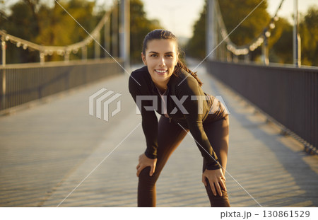 Portrait of happy smiling sporty woman looking at camera after sport fit exercises outdoors. Portrait of happy smiling sporty woman looking at camera after sport fit exercises outdoors. 130861529
