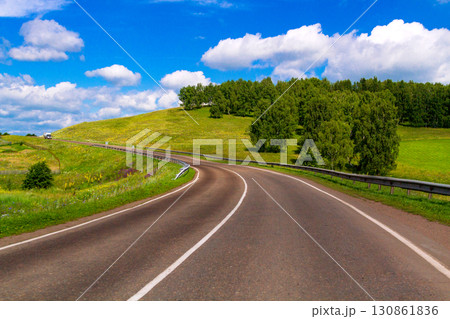 A road and white clouds on the sky A road and white clouds on the sky 130861836