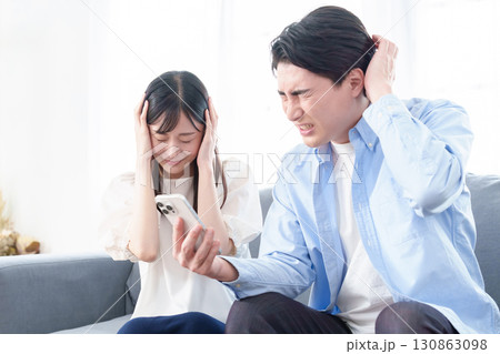 スマートフォンを使う男女 パニック 混乱 スマートフォンを使う男女 パニック 混乱 130863098