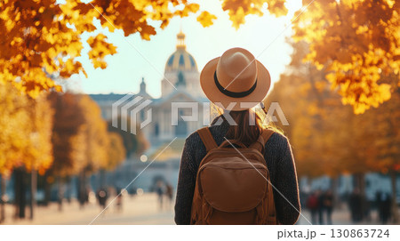 paris woman hat walks city street scene trees 130863724