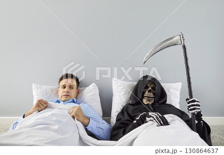 Haunted Man Lying in Bed with Grim Reaper and Scythe Haunted Man Lying in Bed with Grim Reaper and Scythe 130864637