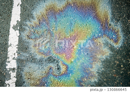 Vibrant Oil Slick Creates a Colorful Display on Asphalt Surface in Urban Setting Vibrant Oil Slick Creates a Colorful Display on Asphalt Surface in Urban Setting 130866645