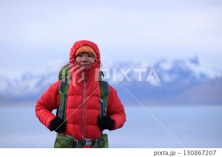 Backpacking woman hiking on high altitude mountain top Backpacking woman hiking on high altitude mountain top 130867207