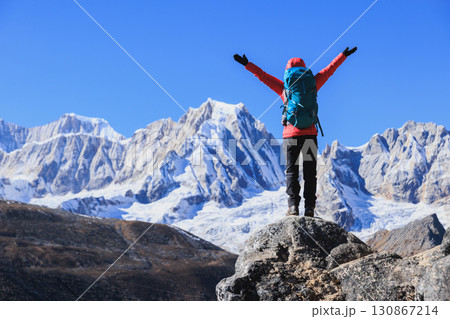Successful woman hiking on high altitude mountain top 130867214