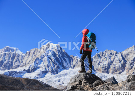 Successful woman hiking on high altitude mountain top Successful woman hiking on high altitude mountain top 130867215