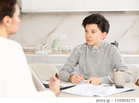 Boy studying with tutor 130869275