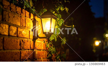 Antique glass bulb lantern on an old brick wall street at night 130869463