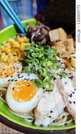 Bowl of ramen with soft-boiled eggs, chicken, corn, tofu and green onions, close-up view Bowl of ramen with soft-boiled eggs, chicken, corn, tofu and green onions, close-up view 130869775