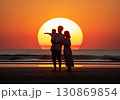 (AI生成)家族イメージ　大きな夕陽と寄り添う親子のシルエット 130869854