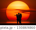(AI生成)家族イメージ　大きな夕陽と寄り添う親子のシルエット 130869860