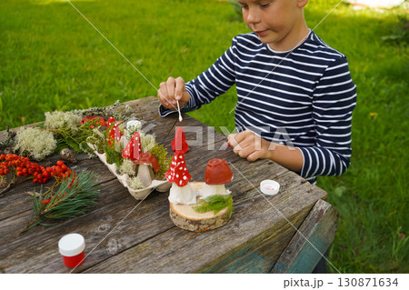 Nature-inspired autumn craft with natural and repurposed materials, depicting a mushroom. Nature-inspired autumn craft with natural and repurposed materials, depicting a mushroom. 130871634
