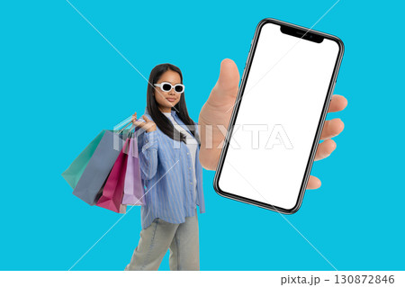 Young shopper enjoys great deals while holding shopping bags Young shopper enjoys great deals while holding shopping bags 130872846