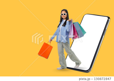 Person carrying vibrant shopping bags celebrates sale day Person carrying vibrant shopping bags celebrates sale day 130872847