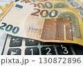 Calculator and Euro Bills. A professional stock photo of 200 euro banknotes on a calculator. Calculator and Euro Bills. A professional stock photo of 200 euro banknotes on a calculator. 130872896