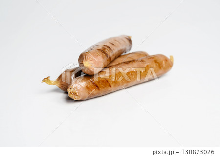 Fried grilled sausage isolated over a white background. Oktoberfest festival Fried grilled sausage isolated over a white background. Oktoberfest festival 130873026