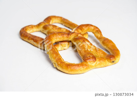 Salty baked brown pretzel isolated over a white background. Oktoberfest festival Salty baked brown pretzel isolated over a white background. Oktoberfest festival 130873034