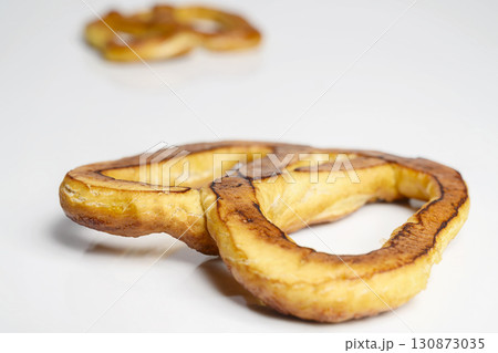Salty baked brown pretzel isolated over a white background. Oktoberfest festival Salty baked brown pretzel isolated over a white background. Oktoberfest festival 130873035