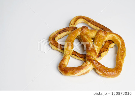 Salty baked brown pretzel isolated over a white background. Oktoberfest festival 130873036
